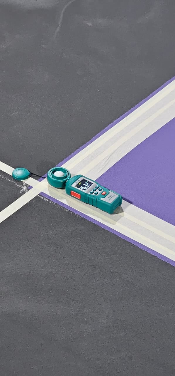Illuminance meter reading being taken on a newly surfaced court