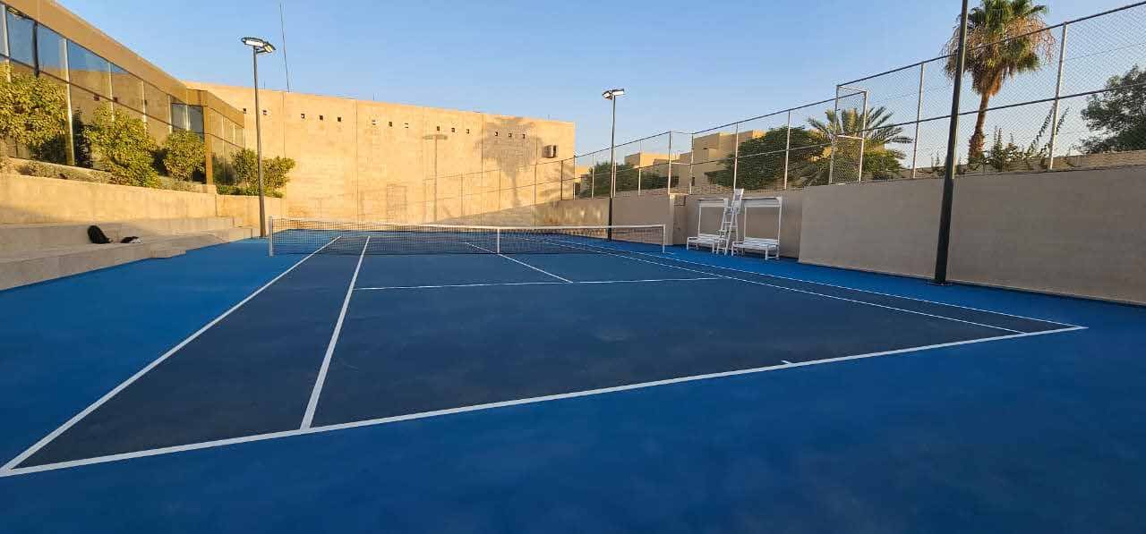 Completed blue acrylic tennis court at a private residence in Saudi Arabia